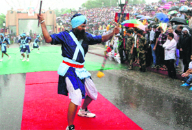 A Nihang performs Gatka during the Independence Day celebrations at the Wagah check post on Thursday.