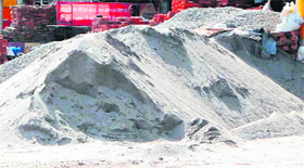 A heap of sand stocked for sale outside a shop in Amritsar.