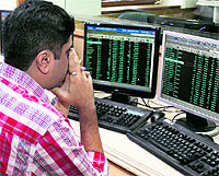 A broker watches the downfall of stocks at the Bombay Stock Exchange in Mumbai on Friday