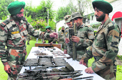 The Army displays ammunition and weapons seized from militants during the past two months at a press conference in Srinagar on Friday. Tribune photo: Amin War 