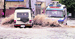 An ambulance makes its way through a heavily inundated Kapurthala Road in Jalandhar on Friday