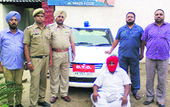 The imposter with the impounded car in police custody at Mandi Gobindgarh on Thursday. a Tribune Photograph