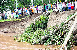 Villagers gather while trying to plug erosion in a 'dhussi bundh' in Ramdas sector of the Ajnala subdivision on Friday
