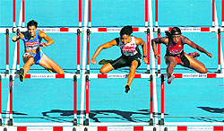 Athletes in action during 100m hurdles on Friday