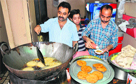 Vinod Kumar fries kachoris at his shop in Keekar Bazar.