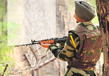 A BSF jawan patrols near the LoC at the Sabjian sector of Poonch. 