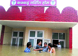 A patient being taken out of a waterlogged nursing home at Tohana in Fatehabad on Saturday