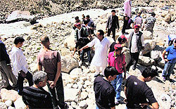 Tourists and local residents clear boulders at the road between Chhota Dhara and Chatru on the Gramphu-Sumdho road