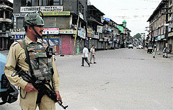 A Central Reserve Police Force jawan on guard at the deserted Budshah Chowk in Srinagar on Saturday