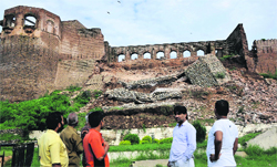 Visitors look at the damaged wall of the Bahu Fort in Jammu on Saturday. Tribune photo: Inderjeet Singh
