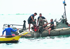 Navy personnel lift a victim from the sea during the rescue operations on Saturday near Cebu.