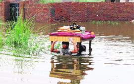 Residents of Udekaran village shift their belongings to a safer place on Sunday.