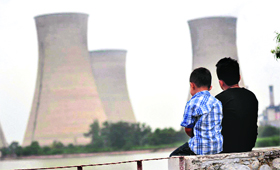 Children sit near the lake in Bathinda that offers a panoramic view of the Guru Nanak Dev Thermal Plant on Sunday afternoon.