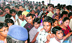 Passengers line up outside a ticket counter at the Chandigarh railway station