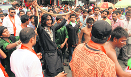 Devotees of Lord Shiva dance with snakes in their hands during the Shiv Shoba Yatra taken out from the Tapkeshwar Temple in Dehradun on Sunday.