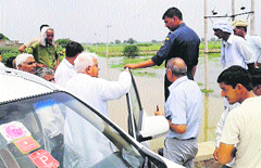 Cooperation and Housing Minister Satpal Sangwan inspects a waterlogged area in Charkhi Dadri block of Bhiwani district.