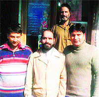 The photograph sent in 2012 by Om Prakash from the Mohajir camp at Muzaffarabad in Pakistan-occupied Kashmir. Om Prakash (centre) is flanked by two young men who supply eatables and tea to the camp