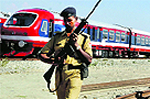 A CRPF personnel stands guard at the Budgam railway station