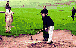 Chief Minister Omar Abdullah plays cricket with children after he was held up due to bad weather at Branwar in Budgam on Sunday