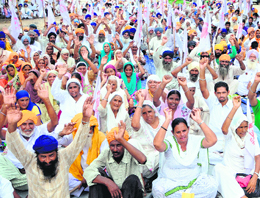 Activists of the Kisan Sangharsh Committee, Punjab, protest outside the office of Amritsar SSP (Rural) on Monday against alleged police links with land mafia and rampant corruption in police department.