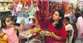 Customers buy rakhis of their choice in Sector 11, Chandigarh, on Monday.