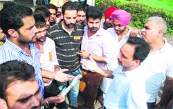 Hostel wardens try to pacify PUSU activists outside the PU Vice-Chancellors office in Chandigarh on Monday. 