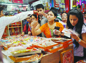 Sisters select rakhis on the eve of Raksha Bandhan at a market in New Delhi on Monday.