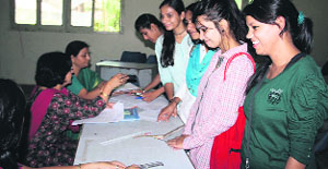 Girls buy nomination forms for the students council poll at MKP Girls College in Dehradun on Monday. 