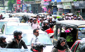 A rally organised by workers engaged under the MNREGA scheme leads to a traffic jam on the Rajpur Road in Dehradun on Monday.