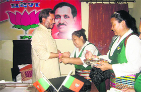Members of the Tibetan Women Association tie rakhis on the hands of Uttarakhand BJP chief Teerath Singh Rawat in Dehradun on Monday.