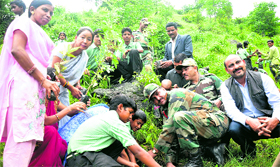 Eco-Task Force jawans in association with students from Help School plant saplings in Senji village on Monday.