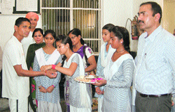 Students of Government Girls Senior Secondary School, Murthal Chowk, tie rakhis to jail inmates at Sonepat District Jail on Monday. Photo: BS Malik