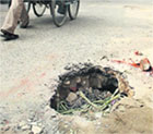 A road constructed about a year ago develops a deep pit at Shaheed Babu Labh Singh Nagar in Jalandhar on Monday. 