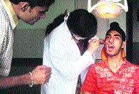 A dentist examines a hearing impaired student at a medical camp at Punjab Institute of Medical Sciences in Jalandhar on Monday. 