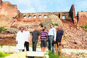 Members of the Jammu Heritage Society visit Bahu Fort after a major wall collapsed due to heavy rains, in Jammu