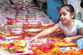 All for love: A child shops for rakhis in Jammu on Monday