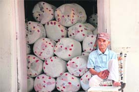An employee of the postal department outside a godown full of pending mail on Monday