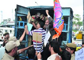 Members of the BJP being taken to the police station after they staged a protest against the compensation plan of the state government for rape victims in Srinagar on Monday