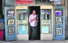 As World Photography Day was celebrated on Monday, Rakesh Kumar Sharma looks for a good shot at his studio, which his father started in 1965.