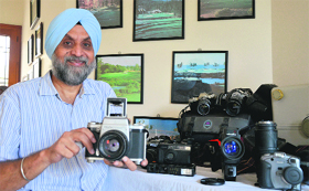 A city-based photographer, Tej Pratap Singh Sandhu, with his collection of old cameras.