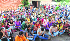 Students of the College of Agricultural Engineering raise slogans against university officials at the PAU in Ludhiana.