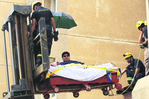 Saudi civil defence members use a forklift to move Khaled Mohsen Shaeri, 20, from his house in Jizan city, before airlifting him to a hospital in Riyadh for medical treatment on Monday. Shaeri weighs 610 kg.