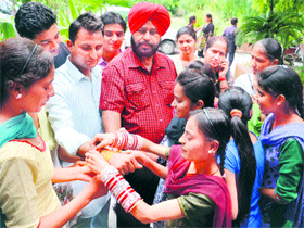 Girls tie Rakhis on the wrists of their brothers on the occasion of Raksha Bandhan in Amritsar on Tuesday.