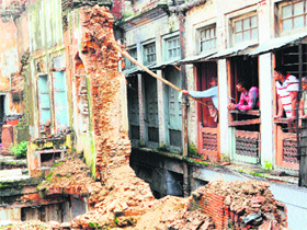 An old rickety building being demolished on the Rora Wali Gali in the walled city by the MC team in Amritsar on Tuesday.