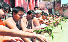 Teerth purohits and Brahmins offer special rituals on Shravani at a Ganga ghat in Haridwar on Tuesday. 