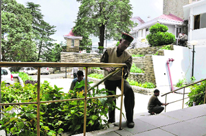 Workers prepare the Vidhan Sabha building for the monsoon session of the state Assembly in Shimla on Tuesday.