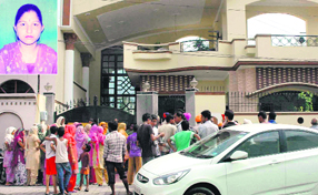 Residents gather outside the house of Satwinder Kaur (inset), who was murdered at her house at Gulmarg Colony in the Ladhewali locality in Jalandhar on Tuesday.
