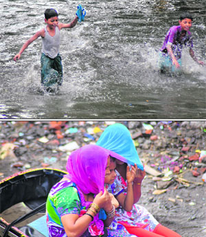 (Top) Children have fun in the rain; and (above) commuters cover themselves with a dupatta after sudden showers lashed the city on Tuesday.