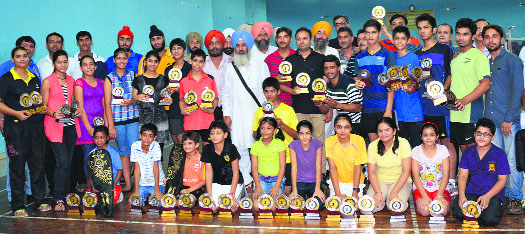 Medal winners of the Ludhiana Open District Badminton Championship pose for a photograph with chief guest Balwinder Singh Bains, MLA, and others.