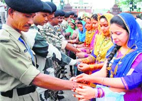 Valiant brothers: Schoolgirls tie Rakhis on the wrists of the Border Security Force personnel on Raksha Bandhan at the Wagah border post on Wednesday
